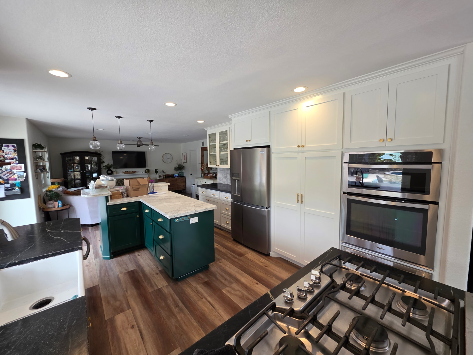 Kitchen with freshly refinished white and deep green cabinets